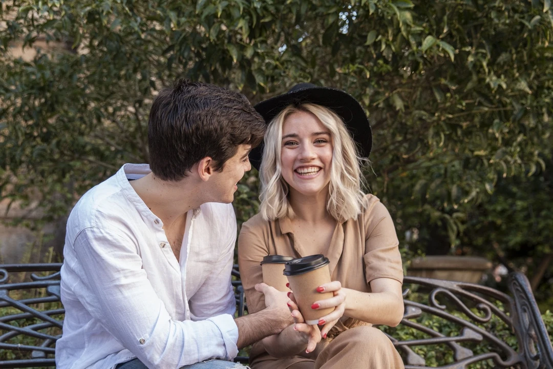 smiley-couple-enjoying-coffee-bench.jpg